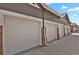 Townhome garage featuring several garages with white doors and brick columns at 14353 E 1St Dr # 302, Aurora, CO 80011