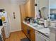 Functional kitchen features light wood cabinets, matching flooring, and white appliances at 14353 E 1St Dr # 302, Aurora, CO 80011