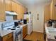 Functional kitchen with modern oven and refrigerator, laminate flooring and cabinets at 14353 E 1St Dr # 302, Aurora, CO 80011
