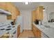 Staged kitchen features laminate floors and cabinetry and modern appliances at 14353 E 1St Dr # 302, Aurora, CO 80011