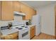Efficient kitchen features light wood cabinets, white appliances, and plenty of countertop space at 14353 E 1St Dr # 302, Aurora, CO 80011