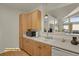 This kitchen features light wood cabinetry and a passthrough to the living area at 14353 E 1St Dr # 302, Aurora, CO 80011