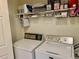 This utility room features a washer and dryer with storage shelves above at 14353 E 1St Dr # 302, Aurora, CO 80011