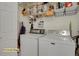 This utility room features a washer and dryer and open storage shelves above at 14353 E 1St Dr # 302, Aurora, CO 80011