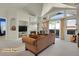 Staged living room featuring cathedral ceilings, fireplace, and sliding glass door to balcony at 14353 E 1St Dr # 302, Aurora, CO 80011