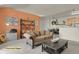 Staged living room features a comfortable couch and access to the kitchen and dining area at 14353 E 1St Dr # 302, Aurora, CO 80011