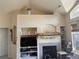 Living room with cathedral ceiling, fireplace, custom built-ins and adjacent entry door at 14353 E 1St Dr # 302, Aurora, CO 80011