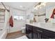 Updated bathroom with dark vanity, white vessel sink, and tile shower at 22586 E Union Cir, Aurora, CO 80015