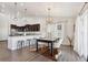 Dining area with a rustic table and cowhide rug, open to kitchen at 22586 E Union Cir, Aurora, CO 80015