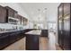 Modern kitchen with dark cabinetry, granite counters, and stainless steel appliances at 22586 E Union Cir, Aurora, CO 80015