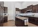 Kitchen with dark cabinets, granite island, and stainless steel appliances at 22586 E Union Cir, Aurora, CO 80015