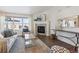 Living room featuring a cozy corner fireplace and large windows at 22586 E Union Cir, Aurora, CO 80015