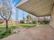 Covered back patio overlooks a large, fenced-in yard with some greenery at 7881 Kenwood St, Commerce City, CO 80022