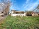 Back exterior view of this house with a modest lawn at 7881 Kenwood St, Commerce City, CO 80022