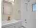Bathroom featuring modern fixtures, white shower and toilet, and a sink with gold faucet at 7881 Kenwood St, Commerce City, CO 80022