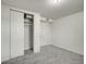 A simple bedroom with a closet, neutral carpet, and white walls at 7881 Kenwood St, Commerce City, CO 80022