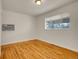 Minimalist bedroom featuring hardwood floors and a bright window at 7881 Kenwood St, Commerce City, CO 80022