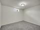 Small bedroom has neutral carpeting, white walls, and a compact window at 7881 Kenwood St, Commerce City, CO 80022