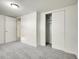 Cozy bedroom with neutral carpeting, white walls, and a closet for storage at 7881 Kenwood St, Commerce City, CO 80022