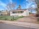 Quaint single-story home featuring a partially fenced yard and off-street parking at 7881 Kenwood St, Commerce City, CO 80022