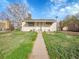Charming single-story home with a well-maintained lawn and inviting walkway at 7881 Kenwood St, Commerce City, CO 80022
