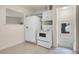 Efficient kitchen layout with white appliances and cabinets, ready for cooking at 7881 Kenwood St, Commerce City, CO 80022