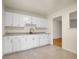 Well-maintained kitchen with white cabinets and a view to another room at 7881 Kenwood St, Commerce City, CO 80022