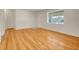 Bright and airy living room with gleaming hardwood floors and natural light at 7881 Kenwood St, Commerce City, CO 80022