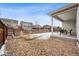 Spacious backyard featuring a patio, gravel area, and wooden fence at 9777 W Stanford Ave, Denver, CO 80123