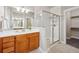 Beautiful bathroom featuring glass shower and wood vanity with marble countertop at 9777 W Stanford Ave, Denver, CO 80123