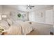 Carpeted bedroom with queen bed, ceiling fan, neutral walls, and lots of natural light at 9777 W Stanford Ave, Denver, CO 80123