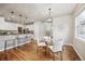 Cozy dining area with modern lighting fixture, connecting the kitchen to the living room at 9777 W Stanford Ave, Denver, CO 80123