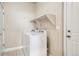 Laundry room with white washer and dryer and open shelving at 9777 W Stanford Ave, Denver, CO 80123