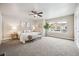 Large main bedroom with carpet flooring, ceiling fan, and natural light at 9777 W Stanford Ave, Denver, CO 80123