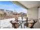 Covered patio area with outdoor seating and views of the fenced backyard at 9777 W Stanford Ave, Denver, CO 80123