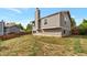 Exterior shot of the backyard with a view of the home's upper level, showcasing the exterior features at 18950 E Kent Cir, Aurora, CO 80013