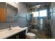 Updated bathroom featuring a tiled glass shower and modern vanity with storage at 18950 E Kent Cir, Aurora, CO 80013