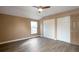 Comfortable bedroom featuring hardwood floors, a ceiling fan, and two closets with ample storage space at 18950 E Kent Cir, Aurora, CO 80013