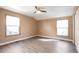 Serene bedroom with hardwood floors, two large windows allowing natural light, and a modern ceiling fan at 18950 E Kent Cir, Aurora, CO 80013