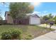 Inviting home with a spacious front yard, mature trees, a two-car garage, and classic brick details at 18950 E Kent Cir, Aurora, CO 80013