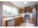 Bright kitchen featuring stainless steel appliances, generous counter space, and a double sink beneath a large window at 18950 E Kent Cir, Aurora, CO 80013