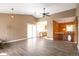 Spacious living room offers hardwood floors, a partial view of the kitchen, and a modern ceiling fan at 18950 E Kent Cir, Aurora, CO 80013