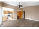 Open concept living space flows into the kitchen area, featuring hardwood floors and bright lighting at 18950 E Kent Cir, Aurora, CO 80013