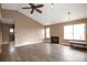 Light-filled living room with vaulted ceilings, a fireplace, hardwood floors, and large windows at 18950 E Kent Cir, Aurora, CO 80013