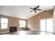 Bright living room featuring vaulted ceilings, a fireplace, hardwood floors, and sliding glass doors at 18950 E Kent Cir, Aurora, CO 80013