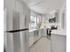 Modern kitchen with stainless steel appliances, stylish backsplash, and a unique black and white patterned floor at 215 E 11Th Ave # D8, Denver, CO 80203