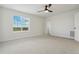 Bedroom with ceiling fan, large window, and neutral carpet at 42968 Colonial Trl, Elizabeth, CO 80107