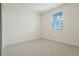 Bright, minimalist bedroom with neutral carpet, white walls, and a window with blinds at 42968 Colonial Trl, Elizabeth, CO 80107