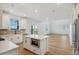 Modern kitchen featuring stainless steel appliances, a center island, white cabinets, and hardwood floors at 42968 Colonial Trl, Elizabeth, CO 80107