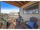 Relaxing balcony with wooden chairs, cushions, and a view of the neighborhood for enjoying outdoor living at 6011 Yarrow St # C, Arvada, CO 80004